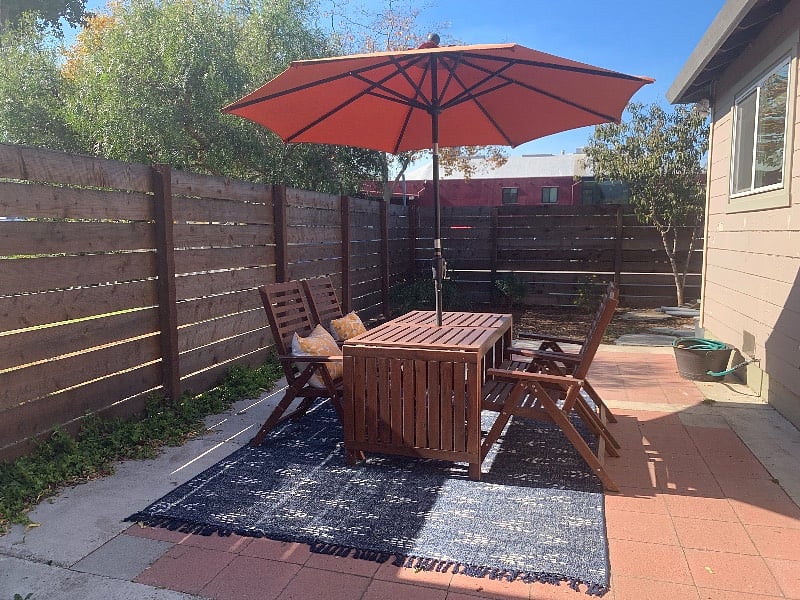 REAR PATIO | Table seats six, umbrella, small garden with Peach Tree