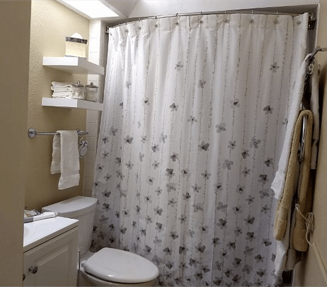 Full-size bathroom (tub & shower), towel warmer, towels, and clothes hamper.