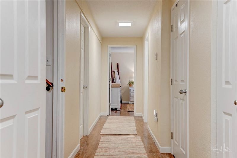 Hallway leading to Downstairs 3rd Bedroom and Private Bath