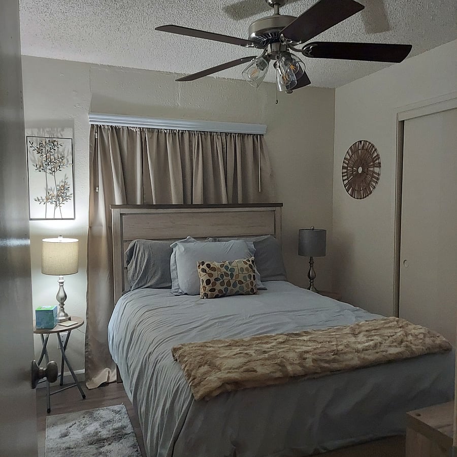 Bedroom 2-Full bed, charge lamps, smart tv, nice size closet, small dresser and storage shelves and a ceiling fan.