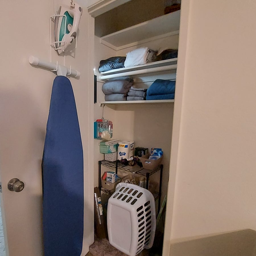 Utility hall closet is stored with additional linens, towels, rugs, iron/board, hair dryer, air freshener, cleaning supplies, vacuum, Swiffer items, broom/ dustpan, hardware, batteries, Fire Kit and First-aid Kit.