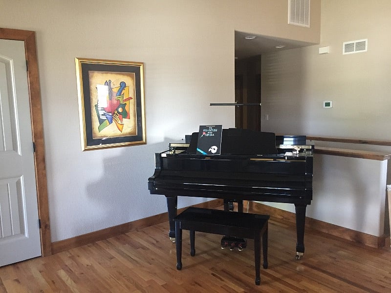 My baby grand piano in the main floor living room as you come into the house.