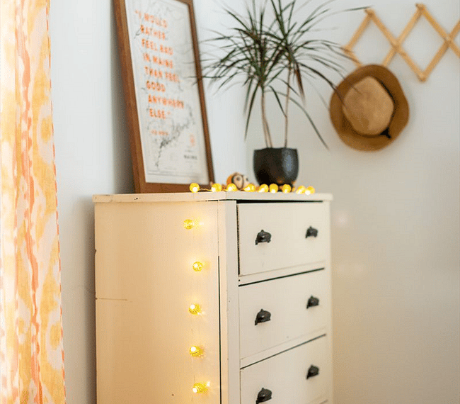 Dresser with accordion hanger and local art.