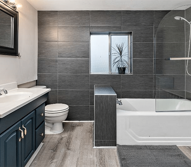 Entrance to the bathroom. Tiled with vinyl flooring. Laundry is on the right - just out of this photo, but shown in another.
