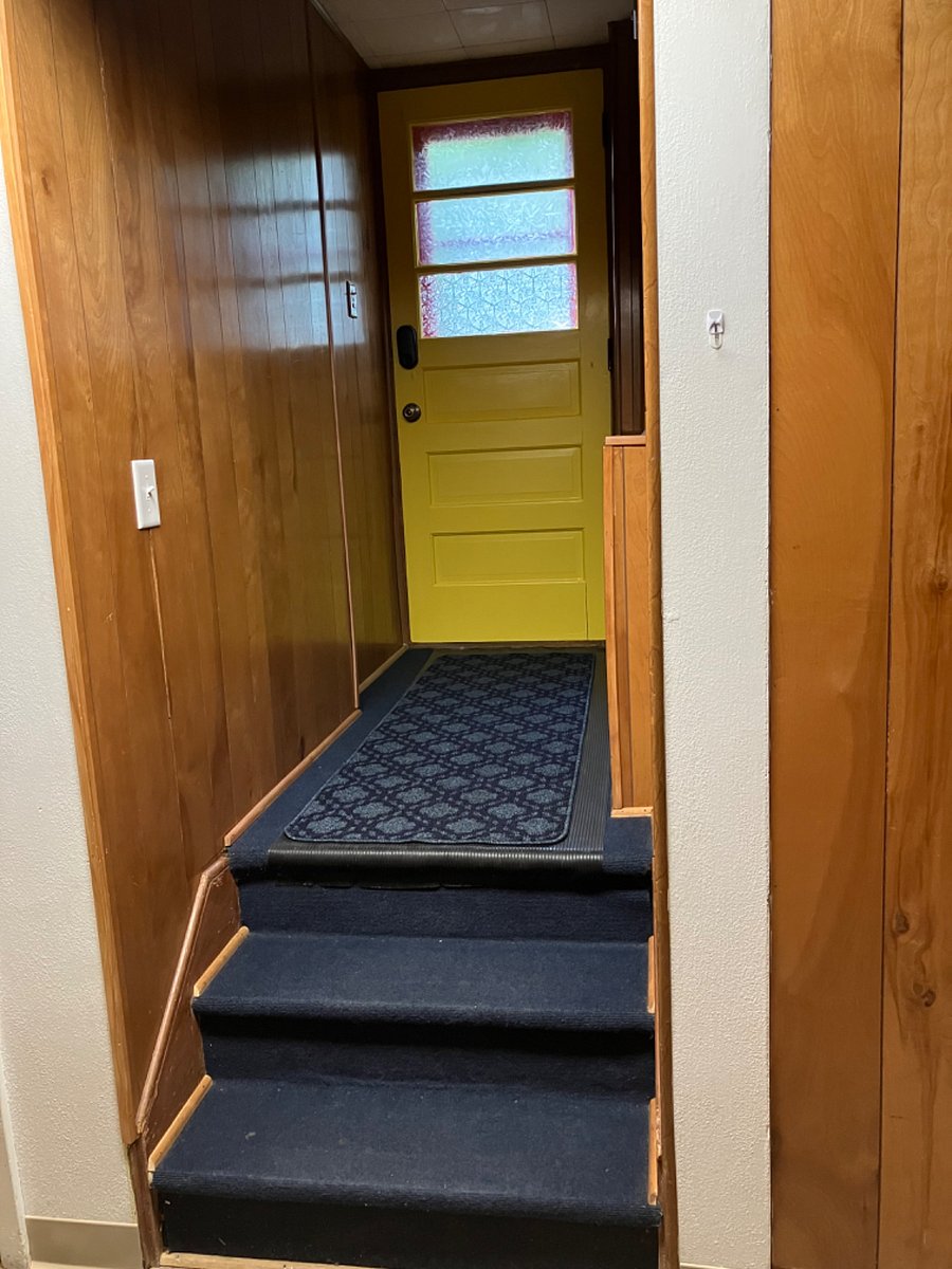 Just a few steps down from the door.