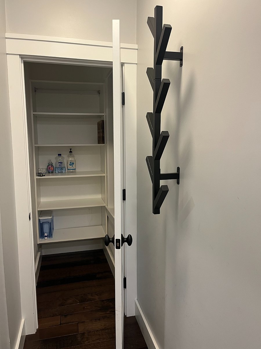 storage closet / coat rack at back entrance 