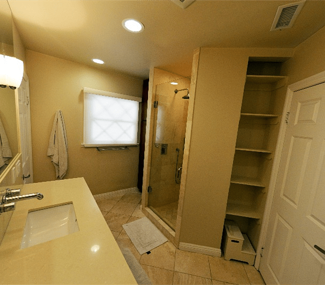 Remodeled bathroom with travertine tile.