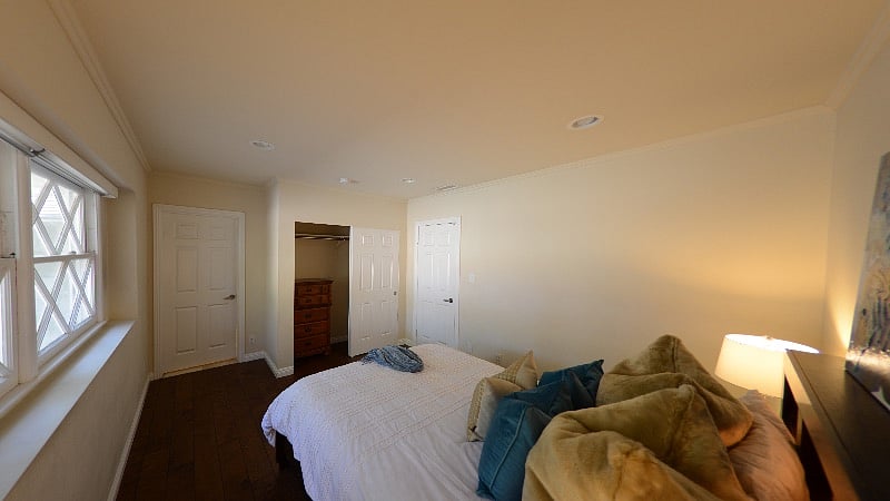 Bedroom, fully furnished with queen bed, night stands, closet, and dresser.