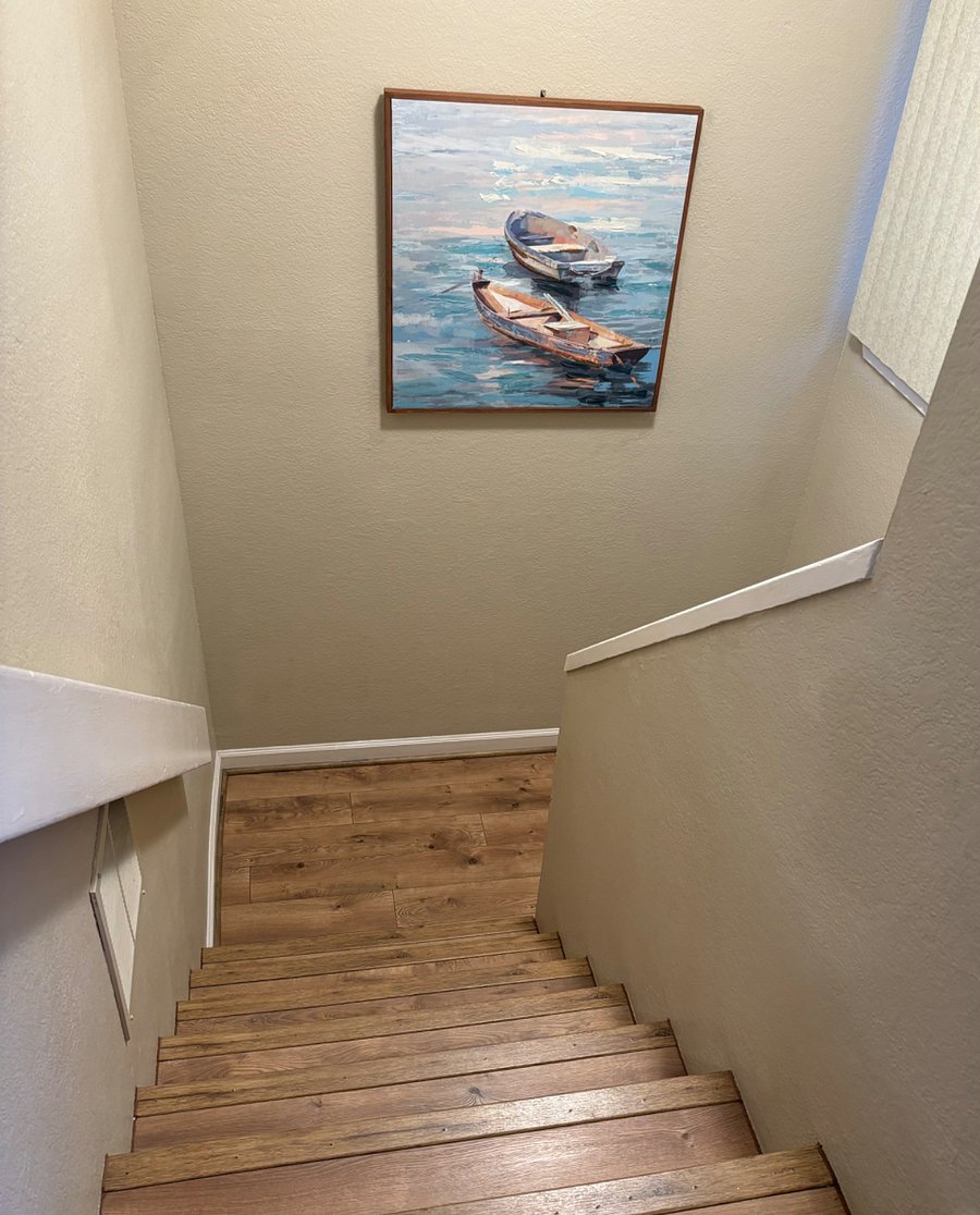 Stairs down to bedrooms/full bath