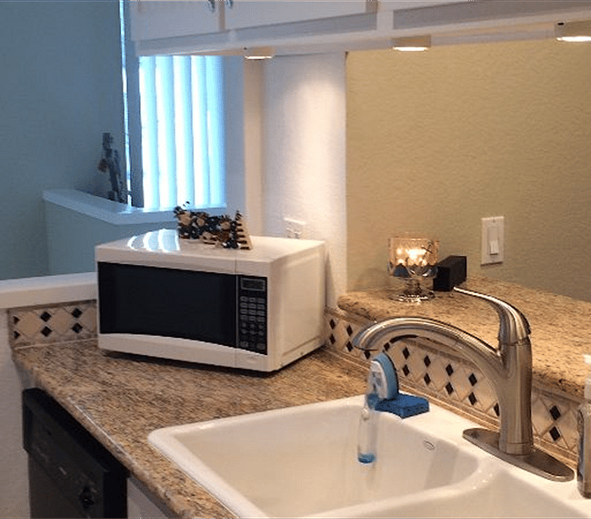 Kitchen looking out to family room and over stairs-microwave, dishwasher, full sized fridge