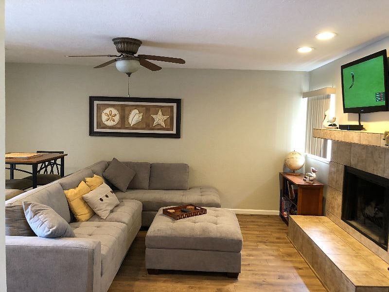 Great room with TV, fireplace, bistro table, and bookshelf