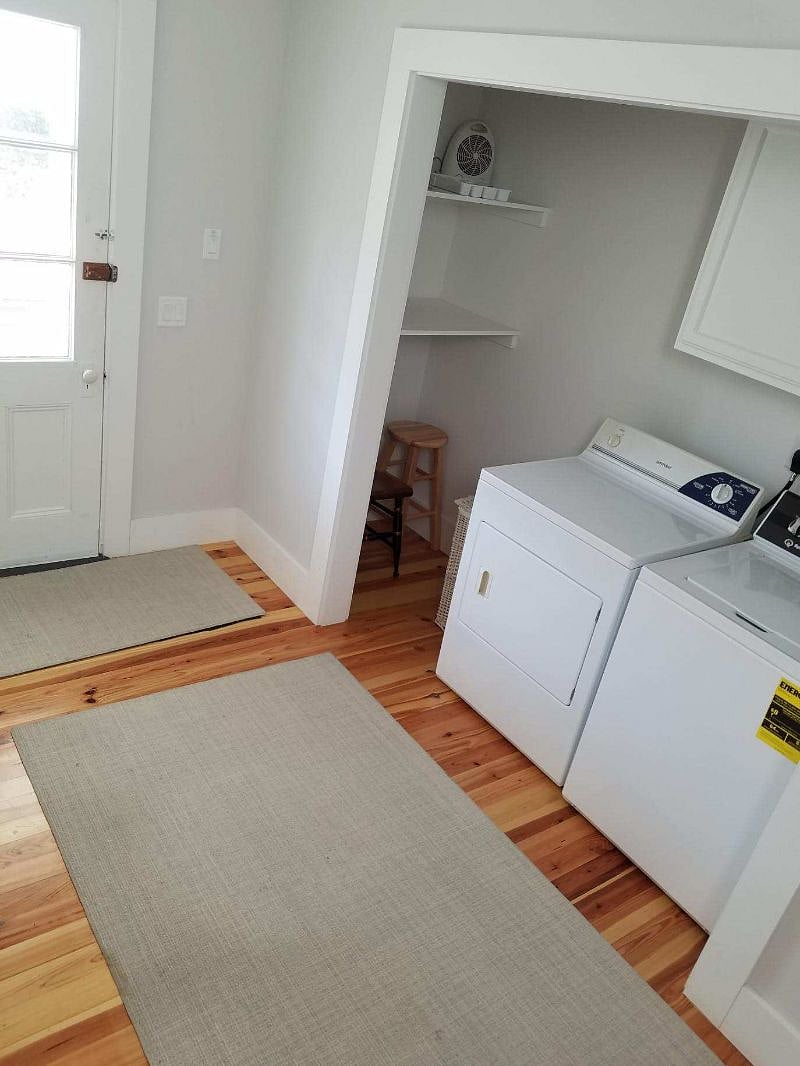 Downstairs entry way with coat closet and new full sized washer and dryer