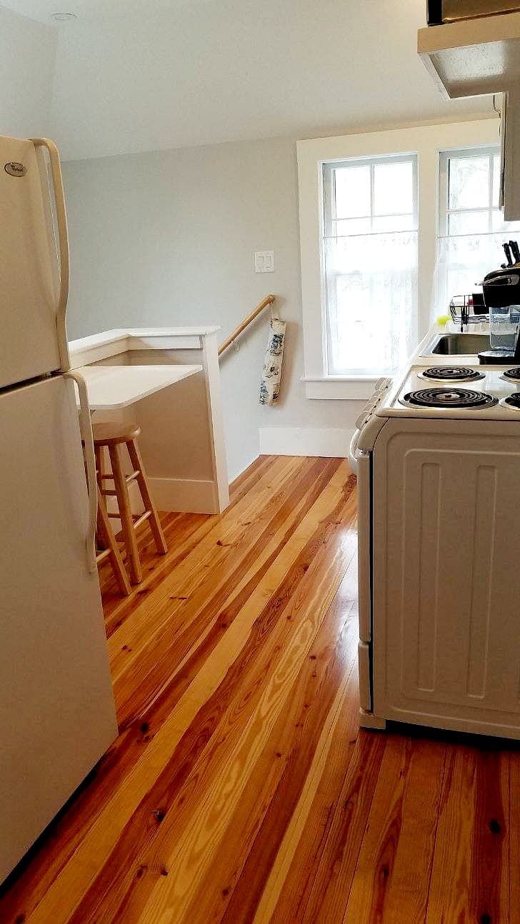 Fully stocked kitchen with Keurig, microwave, new stove and full refrigerator. Small fold up/fold down kitchen table and stool for eating or working.