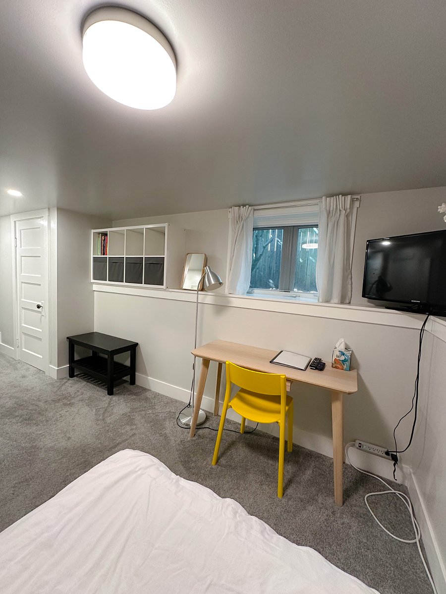 Studio features an operable window, a desk for writing and computing, and a Roku enabled TV.