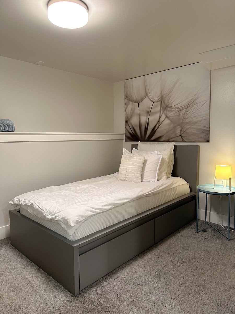 This inviting twin bed features a comfortable mattress and crisp white bedding. There is generous storage under the bed.
