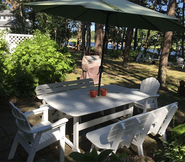 Outdoor patio with table and Weber grill