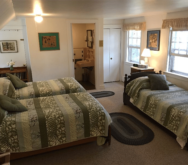 Large bedroom upstairs with three single beds and view of river.  Note upstairs bathroom attached here.