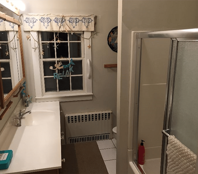 Master bathroom vanity and tub with shower doors.
