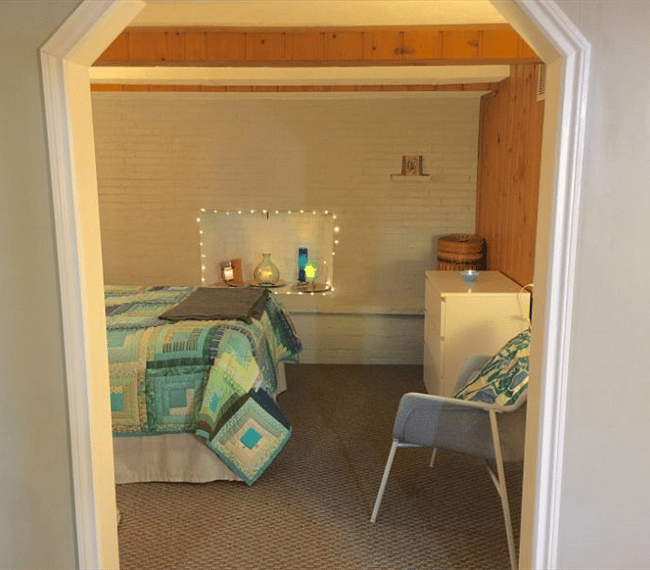Looking in to the sleeping alcove through the archway from the living area.
