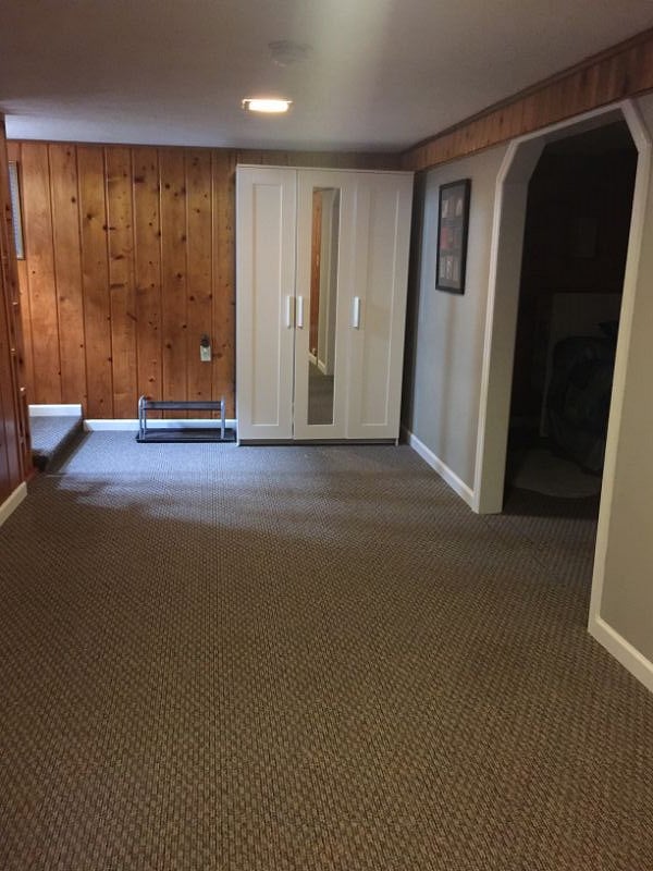 Looking from the living area to the landing of the basement stairs. Hang clothes in this  armoire which also holds extra bedding and towels.