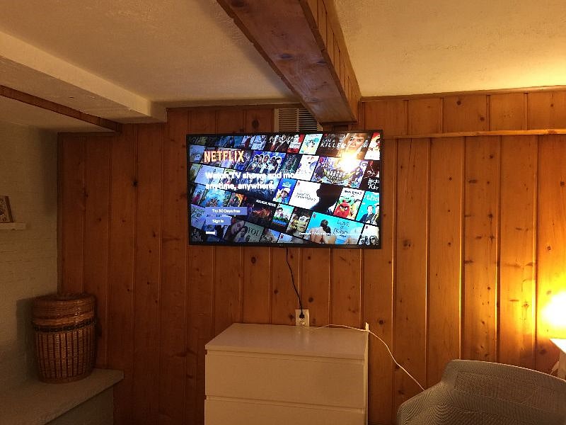 New 52" wifi-connected TV mounted on the wall.
