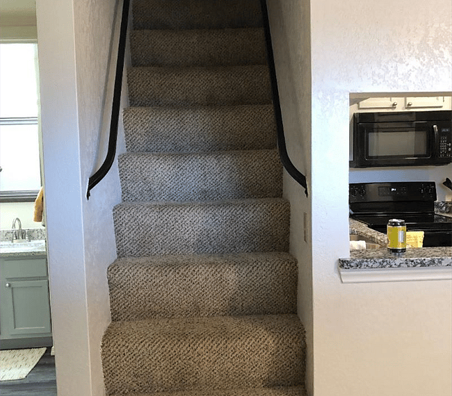 Stairs leading  up to the loft, kitchen to the right and bathroom to the left