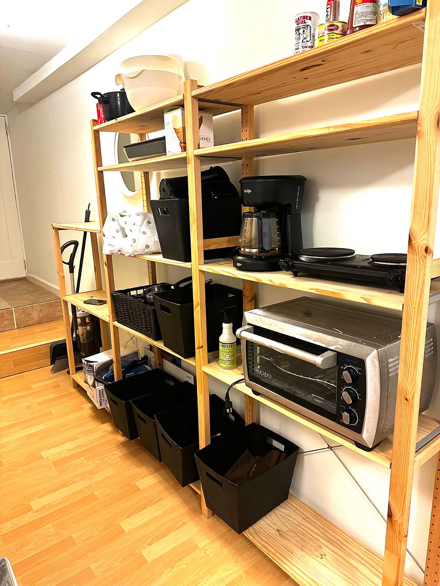 Hallway storage rack with kitchen appliances.