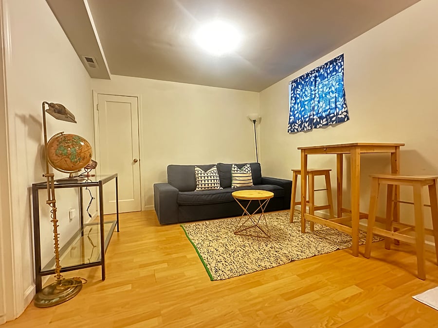 Living room with couch, cafe table, and storage closet.
