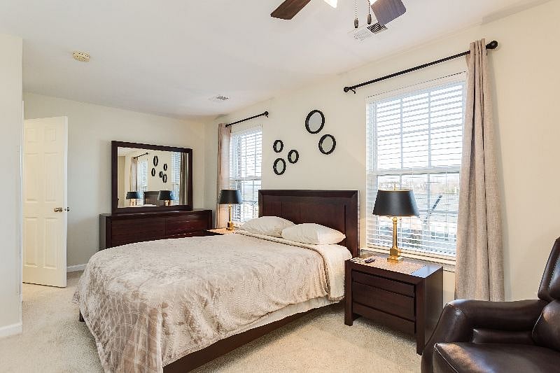Suite 2 with en-suite bath, walk in closet, smart TV, and smart-lock suite door.