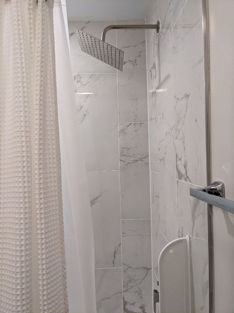 Rain shower head and full bathtub.