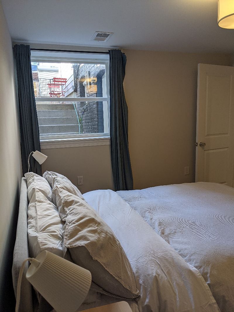 Bedroom window looks out to private patio.