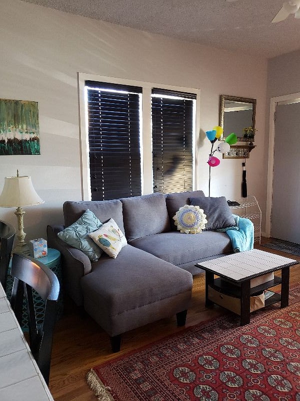 Fold out sofa & front door of downstairs unit.
