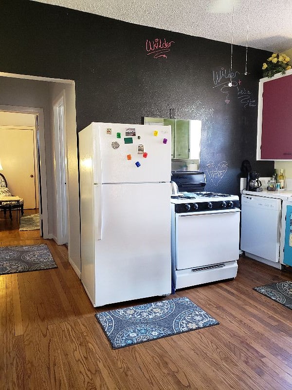 Kitchen with dishwasher of downstairs unit. Both units have full size gas cook stoves.