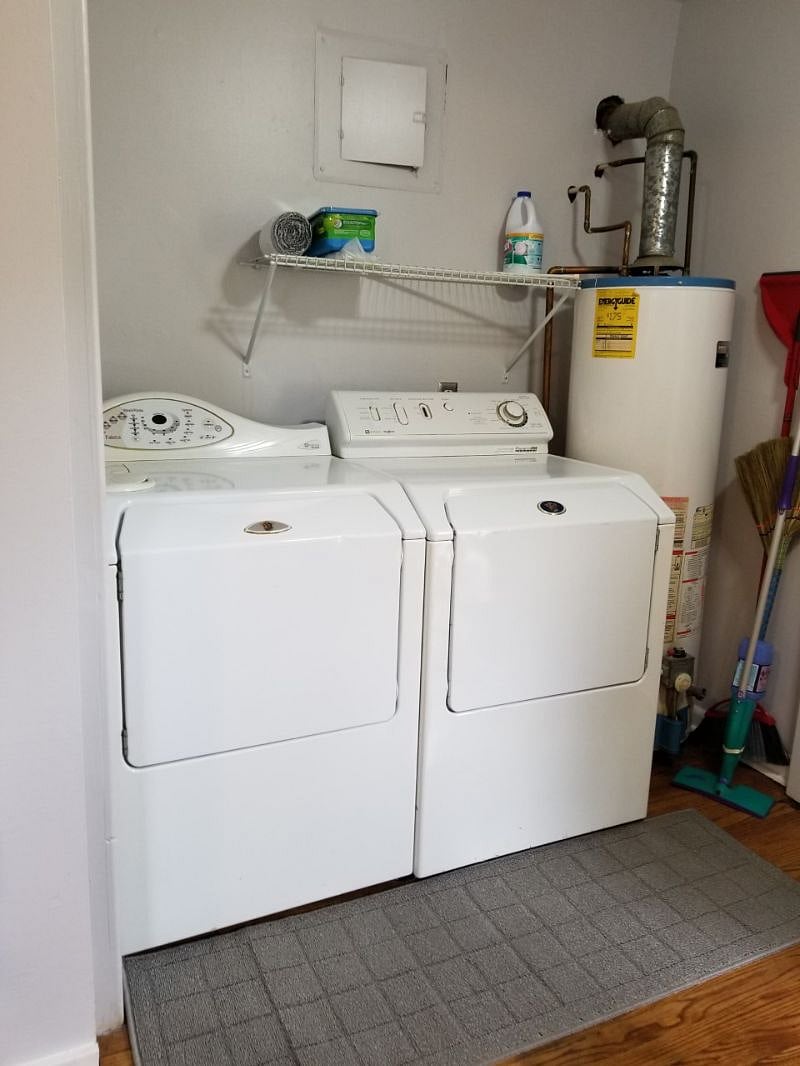 This is laundry room of downstairs unit.