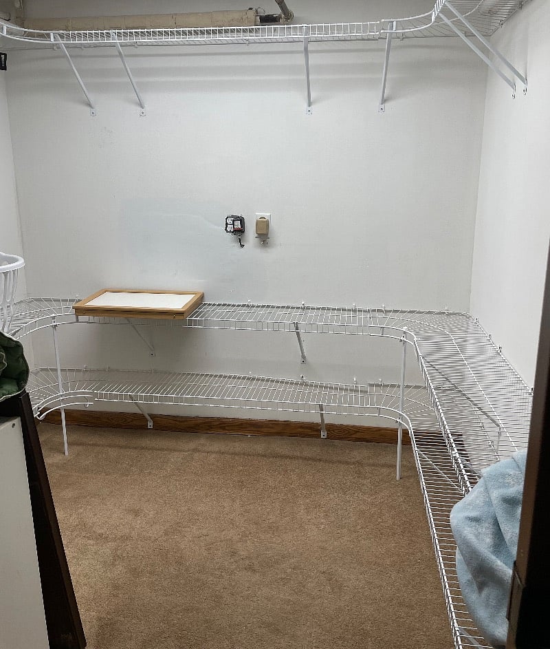 Walking in closet with plenty of storage.