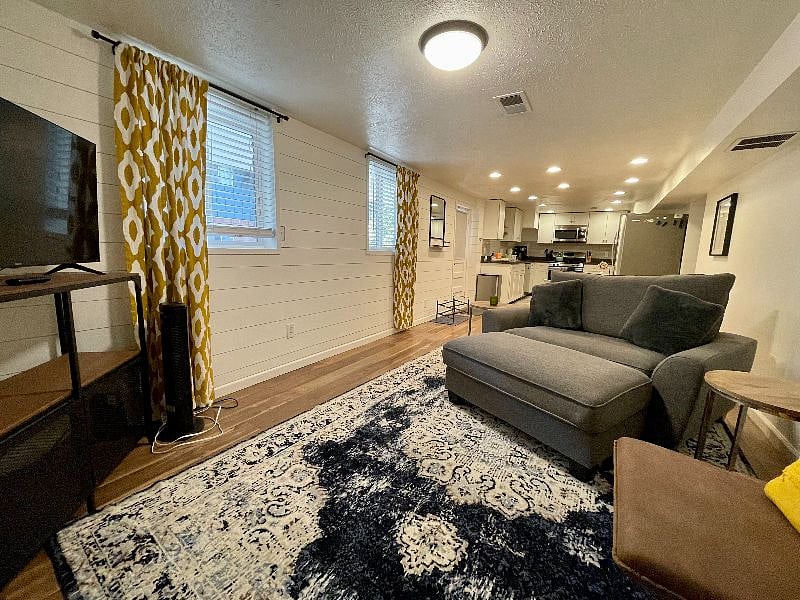 TV and oversized love chair with ottoman.