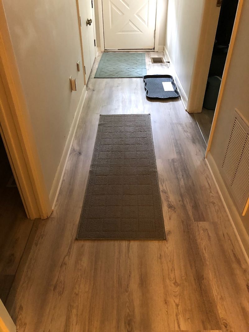 Entrance hall leads to TV/kitchenette/sitting area, full bath, bedroom, and door to laundry and garage