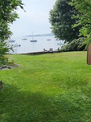 Spacious backyard for lounging, and a firepit overlooking the water.