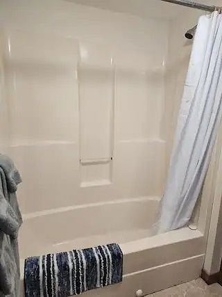 Tub/shower located in full bath on the first floor.