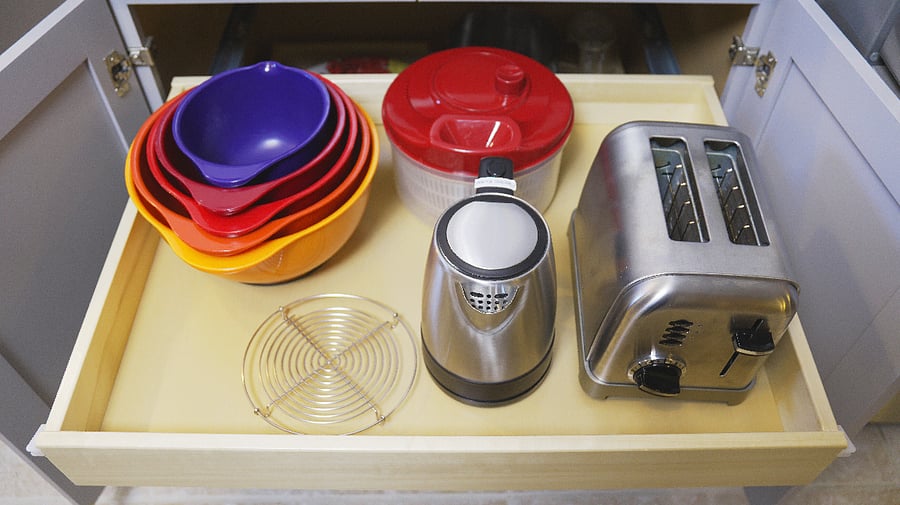 Bowls, salad spinner, toaster, and hot water pot.