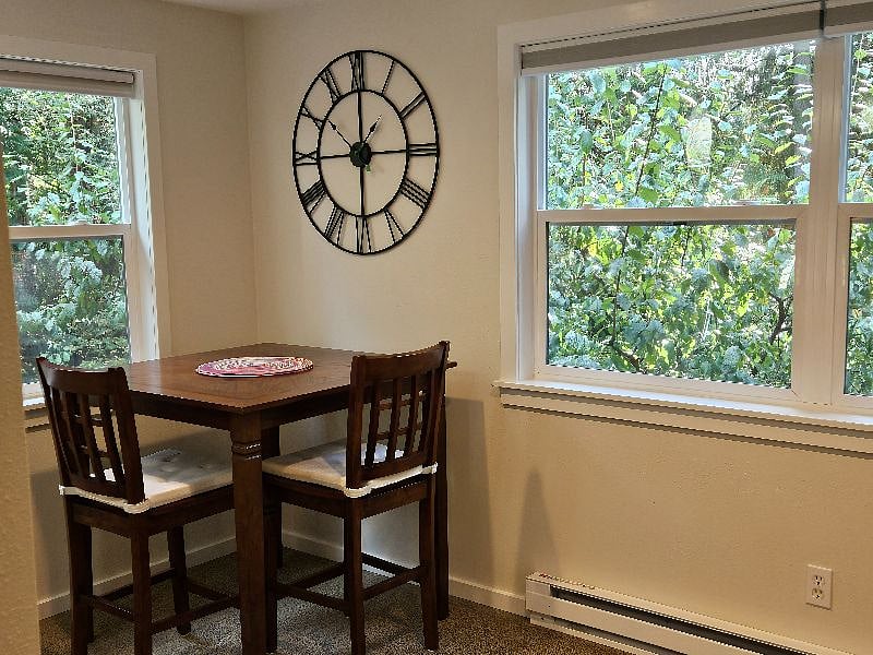 Dining nook overlooks large back yard and woods in back ground.