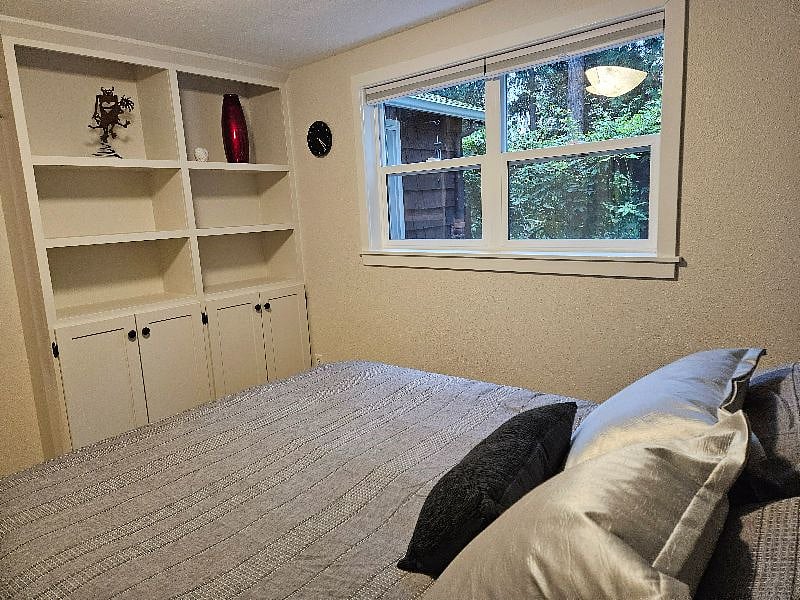 Built in shelves and cupboards in bedroom in addition to full size dresser and closet.