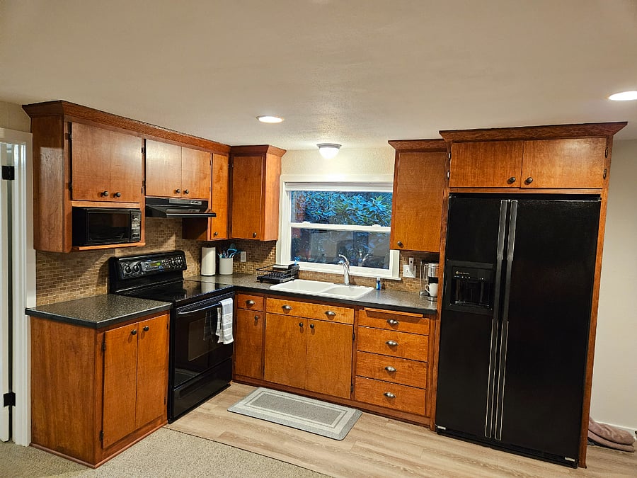 Sweet kitchen featuring full size refrigerator and electric oven/stove top, microwave and all amenities needed to cook up delicious meals.