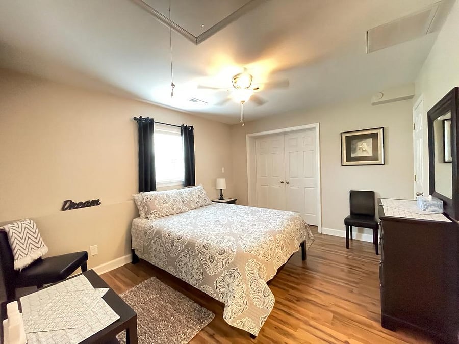 Queen bed with luxurious memory foam mattress and bedding, black out curtains and walk in closet.