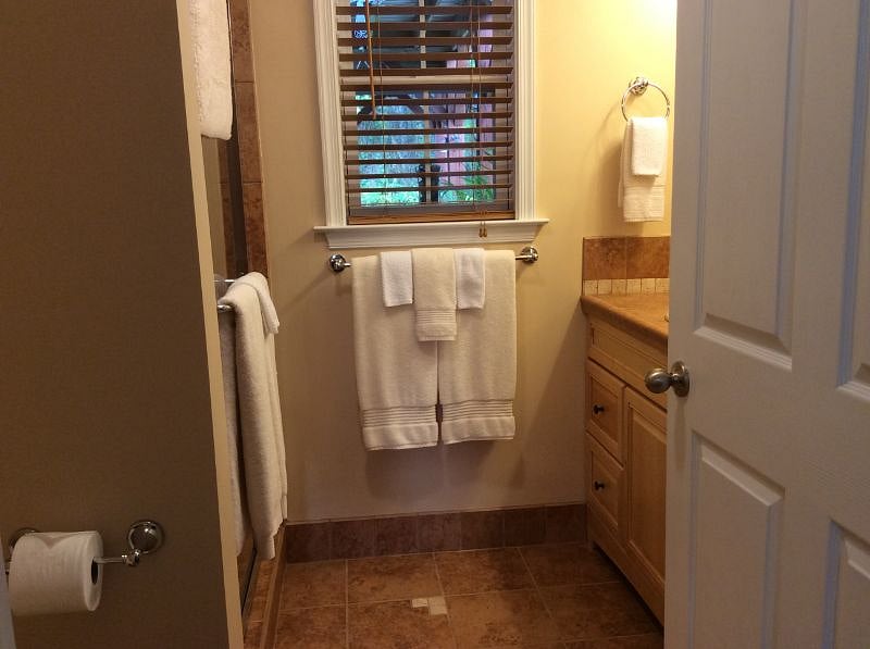 Well stocked bathroom with linen closet
