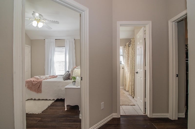 View into private bedroom and private bathroom from foyer.