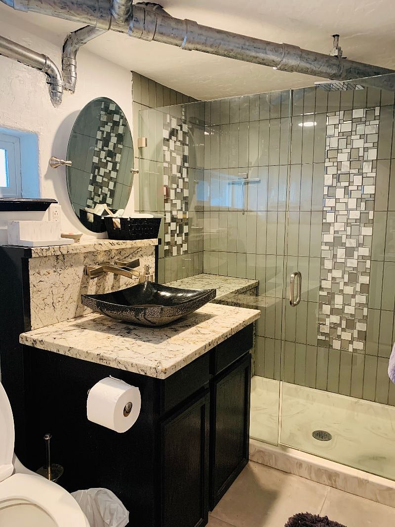 glass enclosed shower with 2 heads including rain