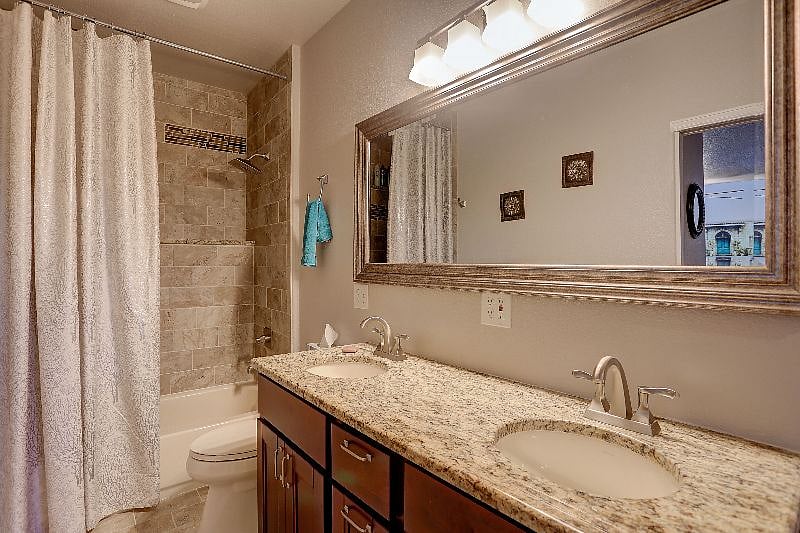 Full Bathroom with Tub and Shower, Toilet and Double Sink.