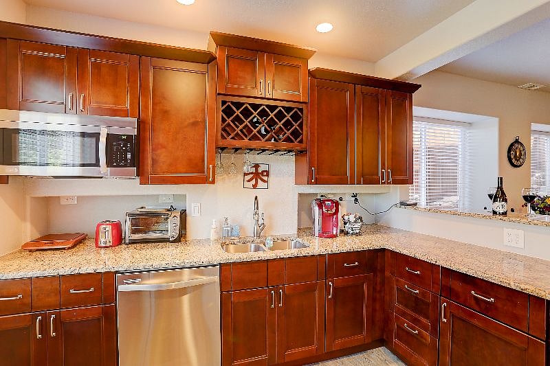 Kitchen with Microwave, Copper Hot Plate, Toaster Oven, Kureg Coffee Maker, Dishwasher,  Double Sink and Breakfast Bar to the right.