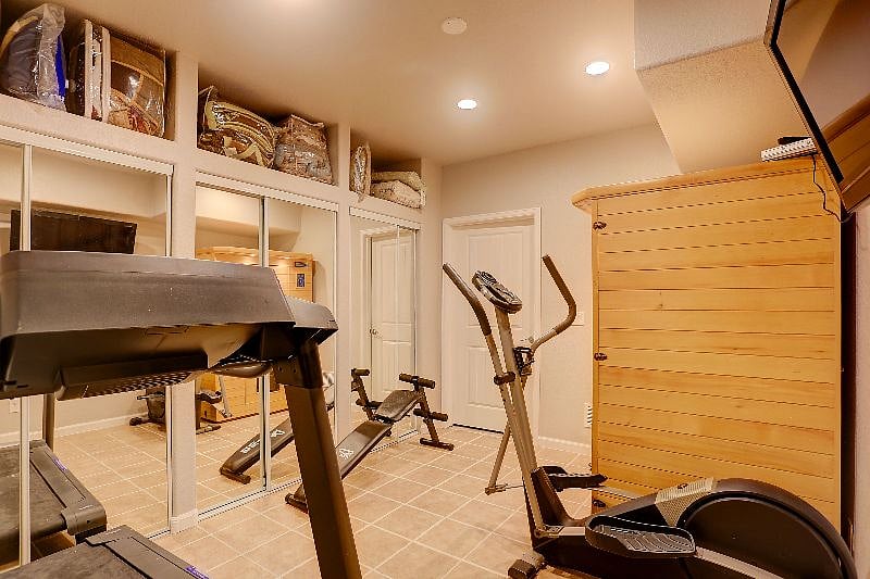 Workout Room with: Treadmill, Cross Train Olyptical, Sit Up Bench, Mirrored Closet Doors with Misc. Equipment: Rebounder, Weights, Massage Table, O2 Machine, Exercise Balls and more.